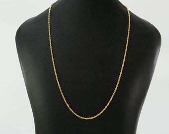 May include: A gold chain necklace on a black display stand. The chain is a rope style with a smooth, polished finish.