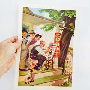 May include: A vintage print depicting a scene outside a bar called "Joe's Place." An artist paints a sign while others observe. A dog sits on the steps. The sign reads "BIERE Old Stock" and "Chez Jos."