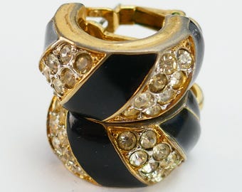 Pendientes vintage de clip de Nina Ricci en tono dorado, esmalte negro y diamantes de imitación transparentes.