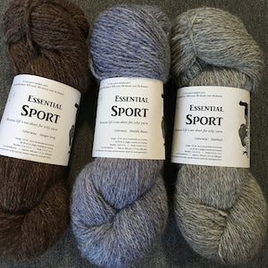 May include: Three skeins of Essential Sport yarn in the colorways Ginger Snap, Moody Blues, and Stardust. The yarn is a sport weight and is made of 50% wool, 40% tencel, and 10% bamboo.