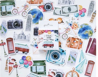 Op de afbeelding: Een set kleurrijke stickers met een reisthema met afbeeldingen van een vintage busje, een camera, een globe, een koffer, een kompas, een telefooncel, een fiets, een gebouw, een luchtballon en een paspoort. De stickers zitten in een doos met de tekst "Travel" en "一个人的旅行" in het Chinees.