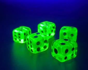 May include: Five glowing green dice with black dots are arranged on a dark blue surface. The dice are translucent, and the dots are clearly visible. The image is brightly lit, highlighting the dice.