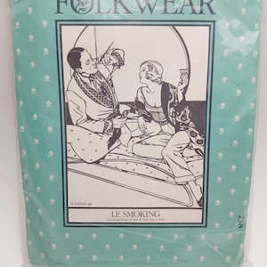May include: A Folkwear sewing pattern packet, featuring a black and white illustration of two people in a smoking jacket and tank top. The packet is teal with a white floral pattern and the text "FOLKWEAR" and "LE SMOKING".