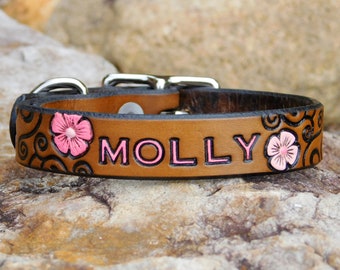 May include: Brown leather dog collar with pink flowers and the name "MOLLY" embossed in pink.