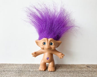 troll doll with gem in belly