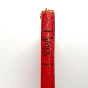 May include: A red book spine with the title "Barefoot Boy With Cheek" by Shulman, published by Blakiston.