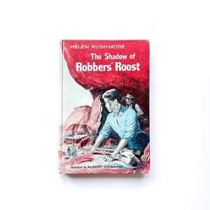 The Shadow of Robbers’ Roost | by Helen Rushmore | Illustrated by Albert Orbaan | Hardcover | 1960