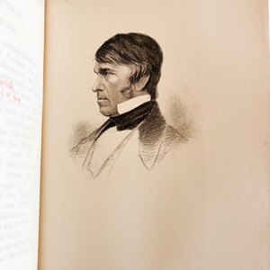May include: A detailed black and white portrait of a man in profile, set against a cream-colored page. The man is wearing a dark jacket, a white collared shirt, and a dark bow tie. The image is from a book.