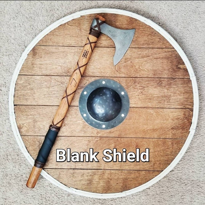 May include: A wooden shield with a white border, a metal axe, and a small metal shield. The axe has a wooden handle wrapped with leather. The text "Blank Shield" is displayed on the shield.