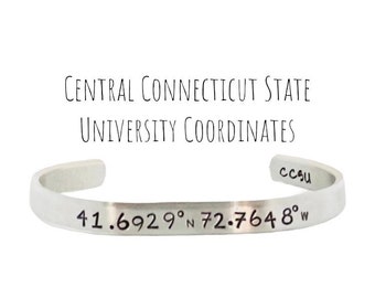 May include: A silver bracelet engraved with "Central Connecticut State University Coordinates" and the coordinates "41.6929° N 72.7648° W".
