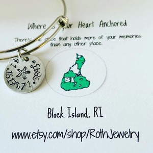 May include: A silver charm bracelet with a charm featuring a starfish and the coordinates 41.10, 71.5. The charm is attached to a silver bangle bracelet. The bracelet is displayed on a white card with the text "Where your heart is anchored. There's no place that holds more of your memories than any other place." and a map of Block Island, RI. The card also includes the text "Block Island, RI" and "www.etsy.com/shop/RothJewelry".