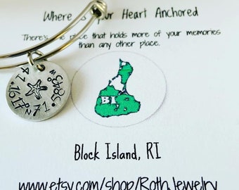 May include: A silver charm bracelet with a charm featuring a starfish and the coordinates 41.10, 71.5. The charm is attached to a silver bangle bracelet. The bracelet is displayed on a white card with the text "Where your heart is anchored. There's no place that holds more of your memories than any other place." and a map of Block Island, RI. The card also includes the text "Block Island, RI" and "www.etsy.com/shop/RothJewelry".