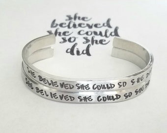 May include: Silver bangle bracelet with the inscription "She believed she could so she did" engraved on it.