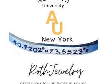 May include: A silver-colored bracelet with engraved coordinates and the text "40.7202°N 73.6523°W". The bracelet is curved and features the text "ADELPHI University" and "New York". The shop name "Roth Jewelry" is also visible.
