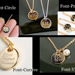May include: Gold and silver necklaces with round pendants. The pendants feature engraved text in various fonts, including initials, words like "BIG" and "LIL", and phrases such as "Best Friends Forever". Some pendants have additional charms.