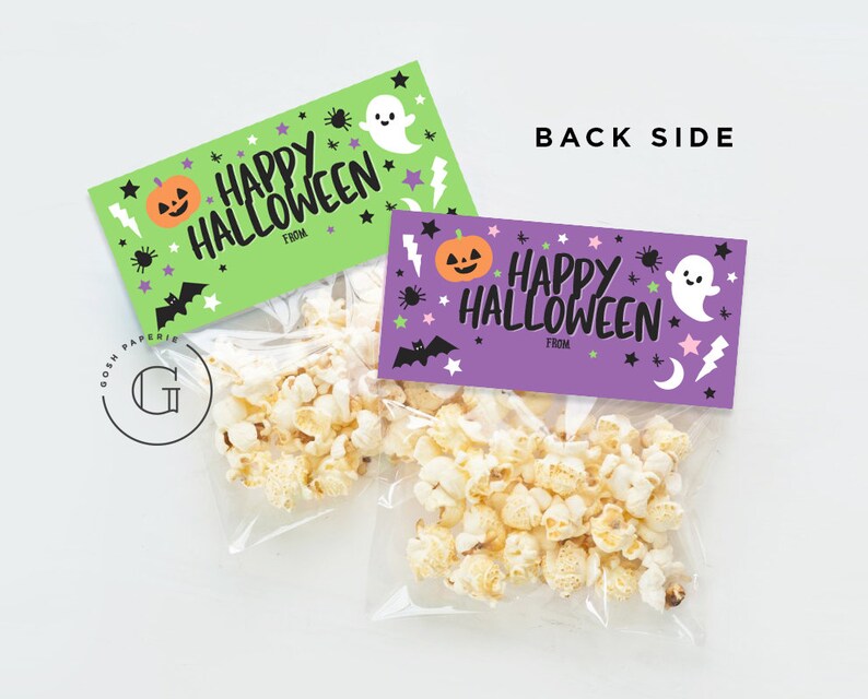 May include: Two Halloween-themed gift bags with popcorn inside. The bags have purple and green tags with the text "Happy Halloween" and a space for "From". The tags are decorated with ghosts, pumpkins, bats, and stars.