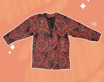 Blazer vintage anni '70 arancione e rosso con stampa paisley, maniche a 3/4 e tasche, taglia S/M.