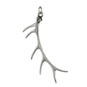 May include: A silver pendant shaped like an antler with a delicate, intricate design. The antler is curved and has multiple points.