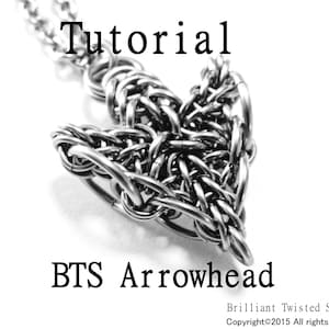 May include: A silver metal arrowhead pendant with a chain, the pendant is made of woven metal wire, the pendant is labelled "BTS Arrowhead" and "Brilliant Twisted Skulls Copyright©2015 All rights reserved"