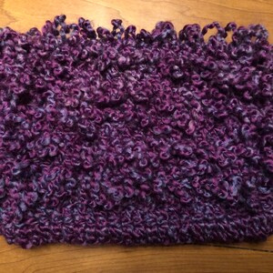 May include: Purple and blue fuzzy yarn scarf with a textured, looped design.