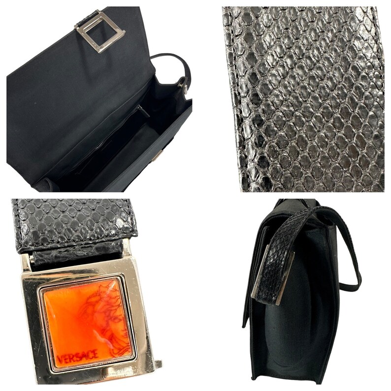 May include: Black handbag with a rectangular shape. The bag features a textured, snake-like pattern on the flap and strap. A silver-toned buckle with an orange and red design and the Versace logo is visible.