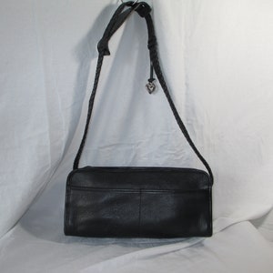 May include: A black leather shoulder bag with a braided strap and a silver heart charm.