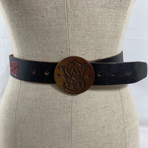 Vintage genuine full grain tooled leather belt size 38 with Smith & Wesson logo buckle 1979