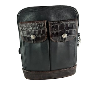 May include: Black leather crossbody bag with two front pockets featuring a brown crocodile-textured flap. The bag has a brown crocodile-textured base and silver-toned hardware. A stylish and functional accessory.