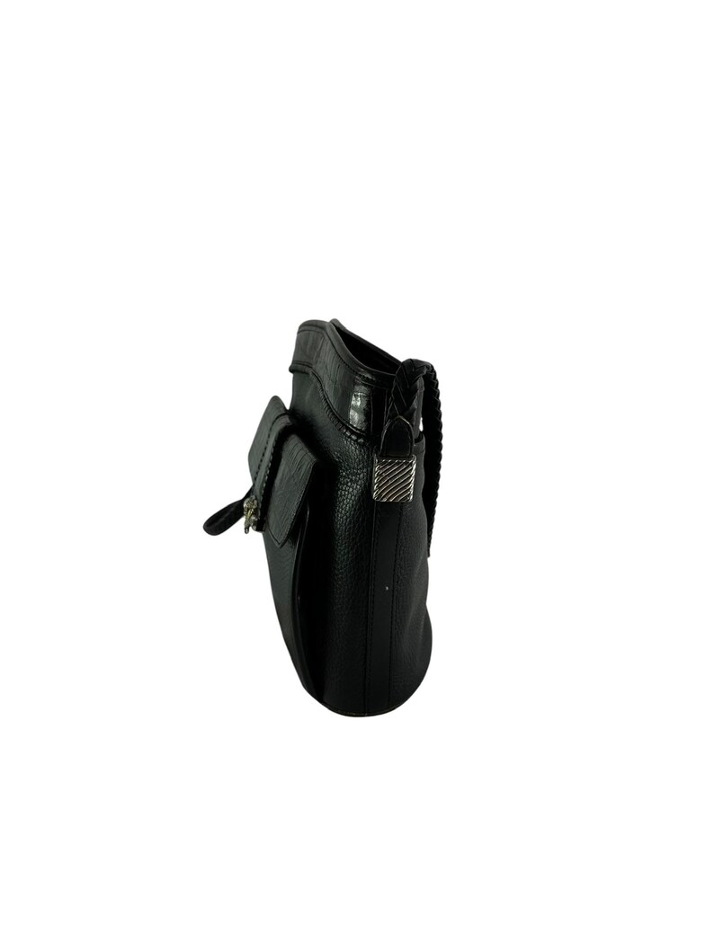 May include: Black leather crossbody bag with a flap closure and a braided strap. The bag features a textured surface and silver-tone hardware on the flap and strap attachments. The bag has a small pocket on the front.