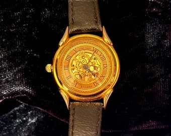 Prevue Gold Tone Skeleton Watch, with Roman Numerals, Black Leather Band, Japan Quartz Movement, 8" Long by 1 1/2" Wide, 1980s 1990s