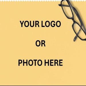 May include: A yellow cleaning cloth with a serrated edge. The text "YOUR LOGO OR PHOTO HERE" is printed in black. Black eyeglasses are in the upper right corner.