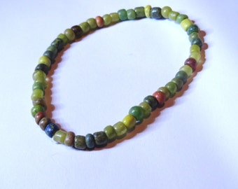 Green Seed Bead Bracelet. Stone beads, matte seed beads with stretch cord. Speckled color.