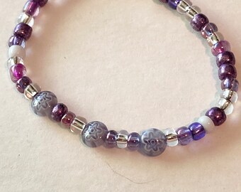 Purple and white seed bead Bracelet. Purple mix and white stretch cord bracelet. Colorful mix limited quantities.