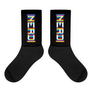 May include: A pair of black socks with a colourful pixelated design that reads "ZERO" on each sock.