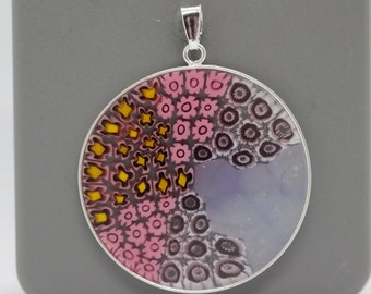 May include: A round silver pendant with a colorful glass design. The glass features a swirling pattern of pink, yellow, and black.