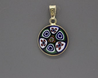 May include: A gold pendant with a round, multi-colored glass design. The design features blue, green, red, white, and yellow colors.