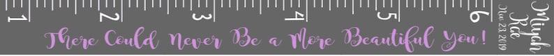 May include: A gray ruler with white markings and the text "There Could Never Be a More Beautiful You!" in lavender script. The ruler is marked in inches, with the text "Mich Rice Est. 2019" in white.