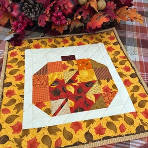 Pumpkin Quilted Table Topper, Halloween Wall Hanging, Autumn Table Runner Pumpkin with Pieced Red Maple Leaf, Orange Border, 18 x 18 inches