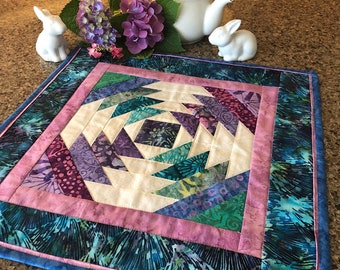 Modern Batik Quilted Table Topper, Pineapple Block in tropical colors of purple, turquoise, lavender, blue, plum, and white, 16.5 x 16.5 in