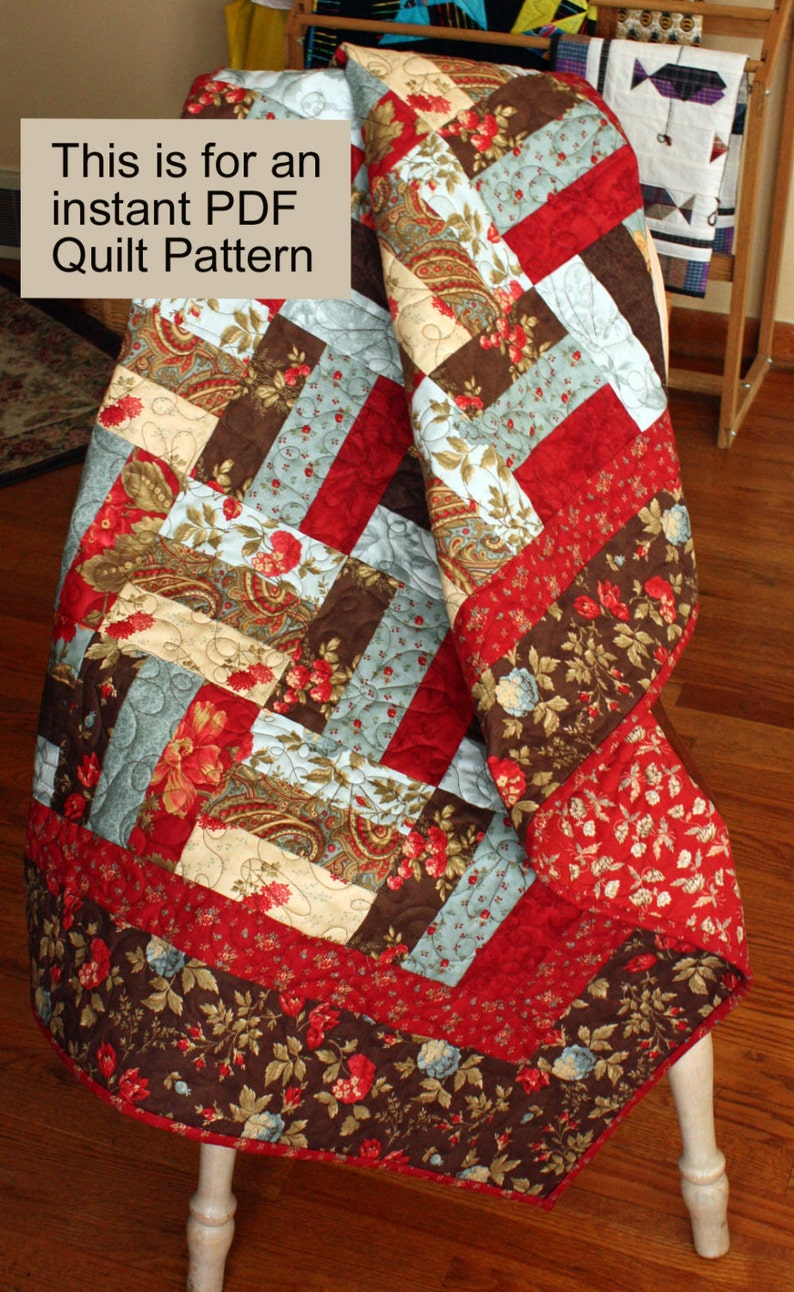 May include: A quilt pattern featuring a patchwork design with red, brown, blue, and cream fabrics. The quilt is folded and displayed on a wooden chair. The text "This is for an instant PDF Quilt Pattern" is visible in the image.