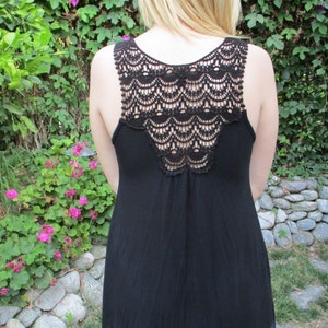 May include: A black sleeveless dress with a crocheted back and a tie-dye hem.
