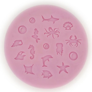 May include: Pink silicone mould with various sea creature shapes, including a starfish, crab, seahorse, and fish.