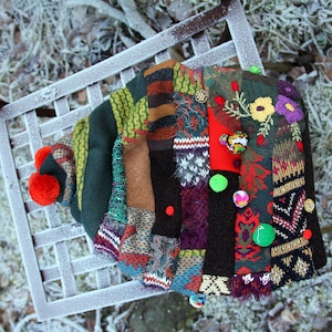 May include: A colorful patchwork knit hat with a pom-pom on top. The hat is decorated with embroidered flowers, buttons, and beads.