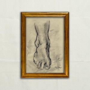 May include: A framed pencil sketch of a foot, with the toes and ankle visible. The artwork is in a gold-colored frame. The drawing is in shades of gray and black, with the artist's signature in the lower right corner.