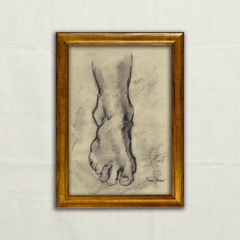 May include: A framed pencil sketch of a foot, with the toes and ankle visible. The artwork is in a gold-colored frame. The drawing is in shades of gray and black, with the artist's signature in the lower right corner.