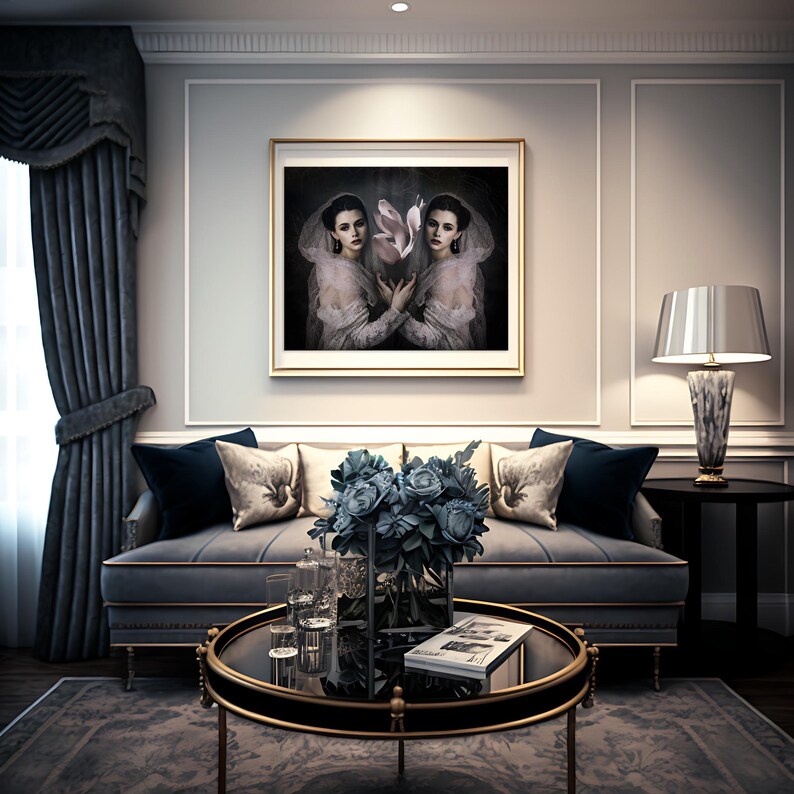 May include: An interior design scene featuring a framed artwork of two women holding a flower, above a gray sofa with decorative pillows. A glass coffee table holds a vase of blue flowers and a book. A lamp and curtains complete the elegant room.