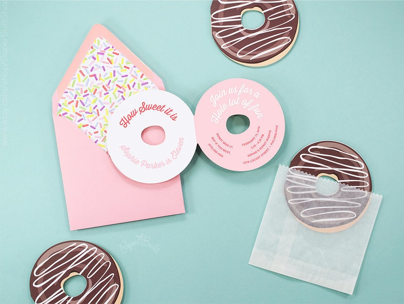 May include: A pink and white donut-shaped invitation with the text "How Sweet it is Sophie Parker is Eleven" and a pink donut-shaped invitation with the text "Join us for a Hole lot of fun".