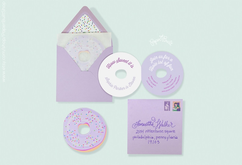 May include: Purple and white donut-shaped invitation with the text "How Sweet it is" and "Sophie Parker is 6" on the front. The back of the invitation has the text "Join us for a Hole lot of fun".