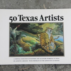 May include: A book cover titled "50 Texas Artists" featuring a painting of two tigers and a bird in a landscape. The cover includes text that reads "A critical selection of painters and sculptors working in Texas by Annette Carlozzi with portraits of the artists by Gay Block."
