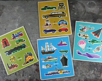 May include: Four colorful cardboard puzzle boards with different transportation themes. The boards are labeled "Trains", "Autos", "Boats", and "Planes". Each board features a variety of vehicles, including trains, cars, boats, and airplanes.